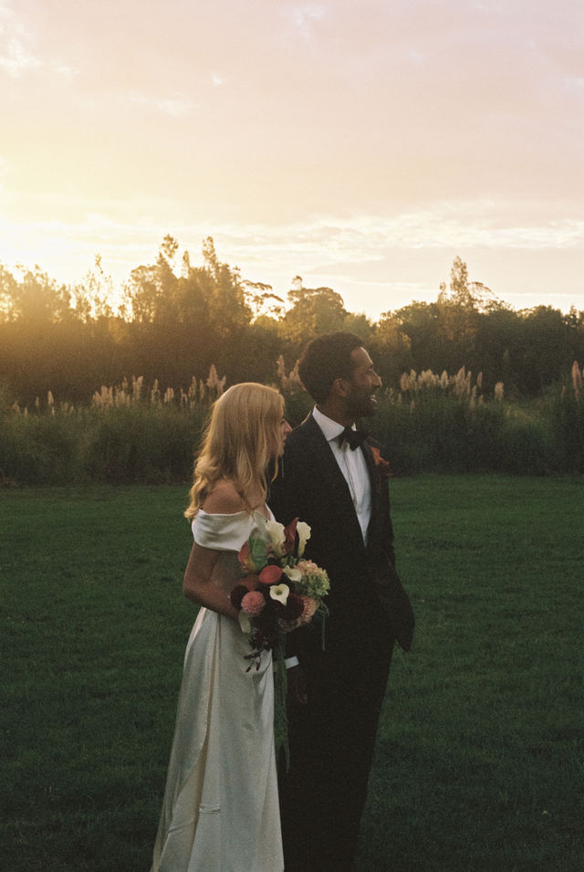 Couple at golden hour in a field, shot on 35mm film